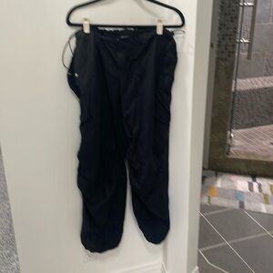 Black parachute pants with drawstring waist and ankles